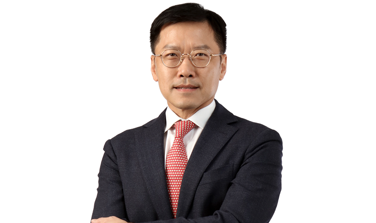 Photograph of Lee Yuan Siong in a dark suit and red tie against a white background