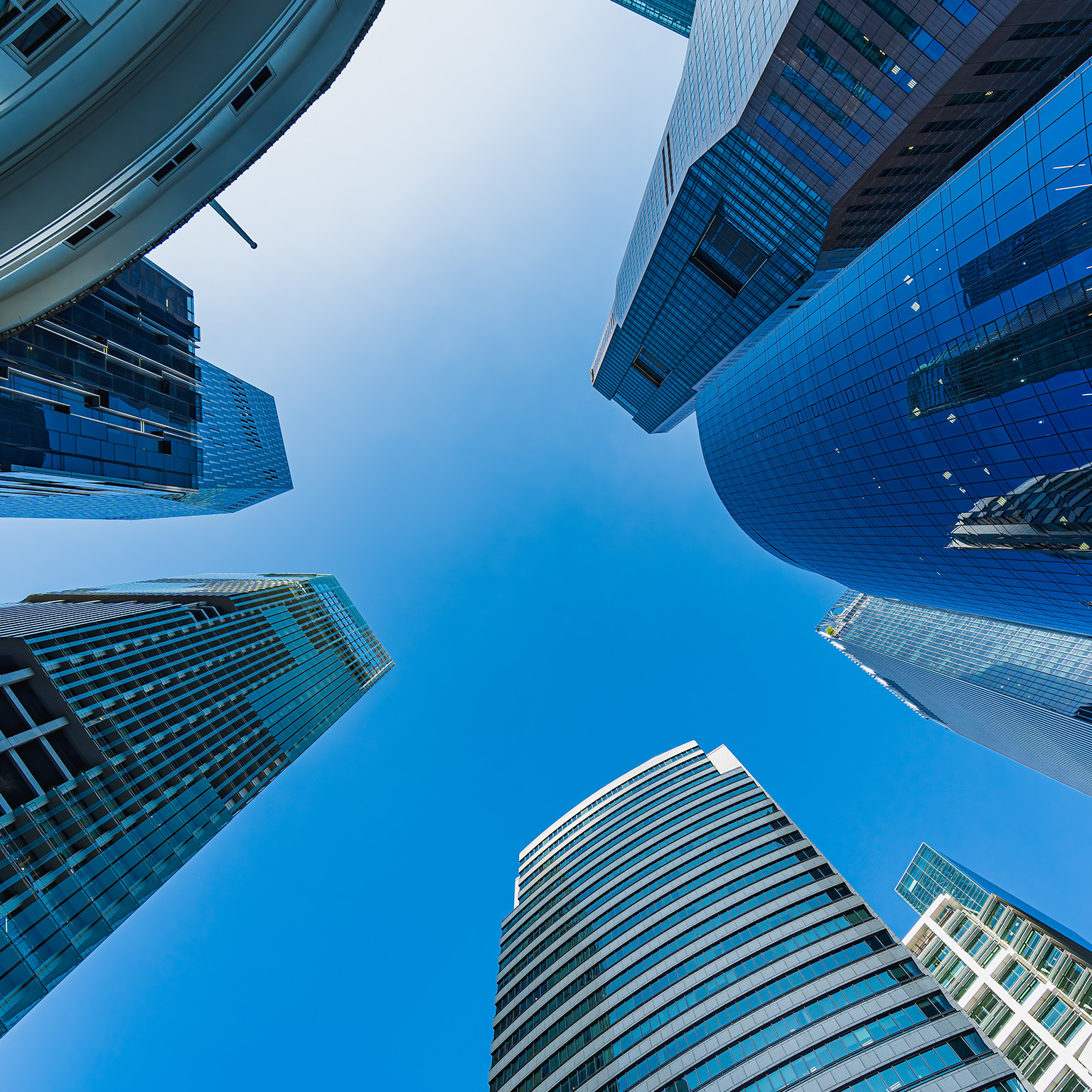 Low angle view of skyscrapers with clear blue sky