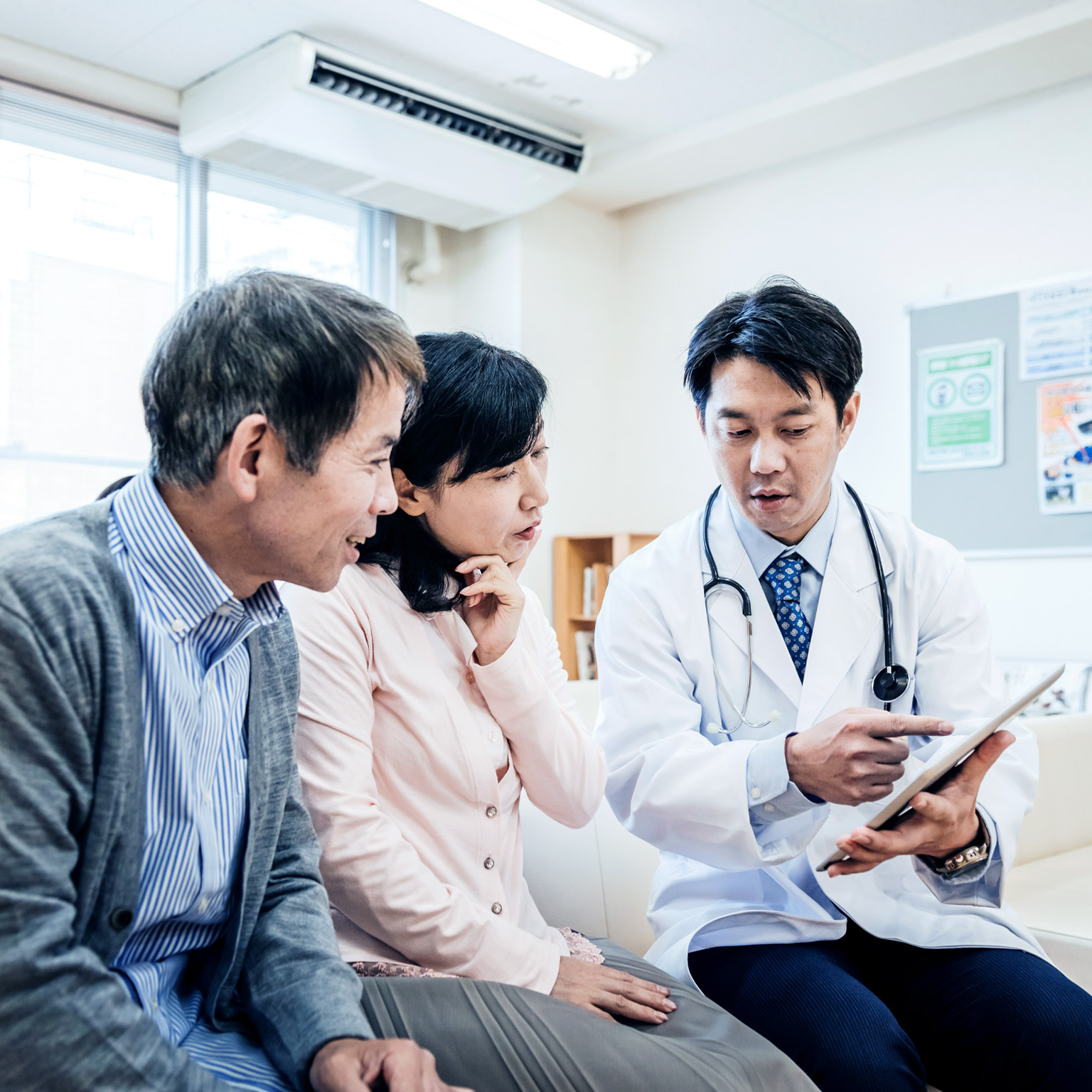Two adults consulting a doctor