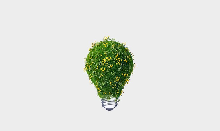 A 3D rendering of light bulb covered with green grass and blooming yellow flowers against light gray background