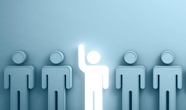 One glowing light man raising his hand among other people