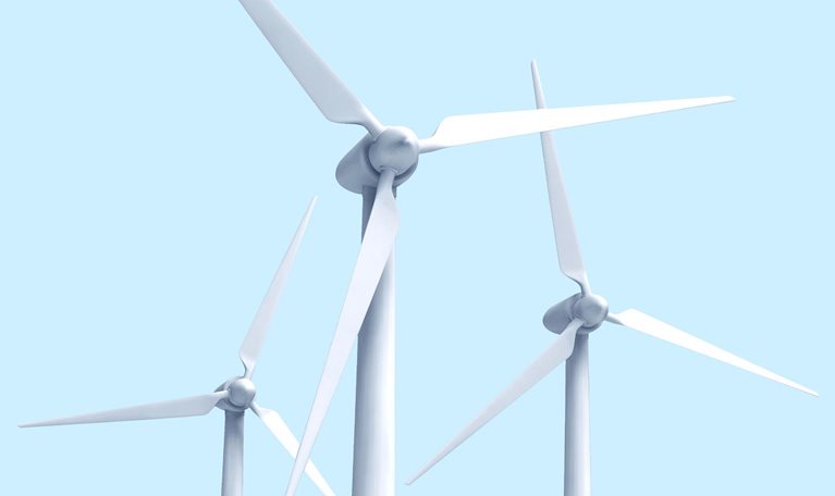 3 wind turbines against a light blue sky.