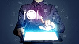 Conceptual close up image of a fine dining waitress placing an order using hologram icons.