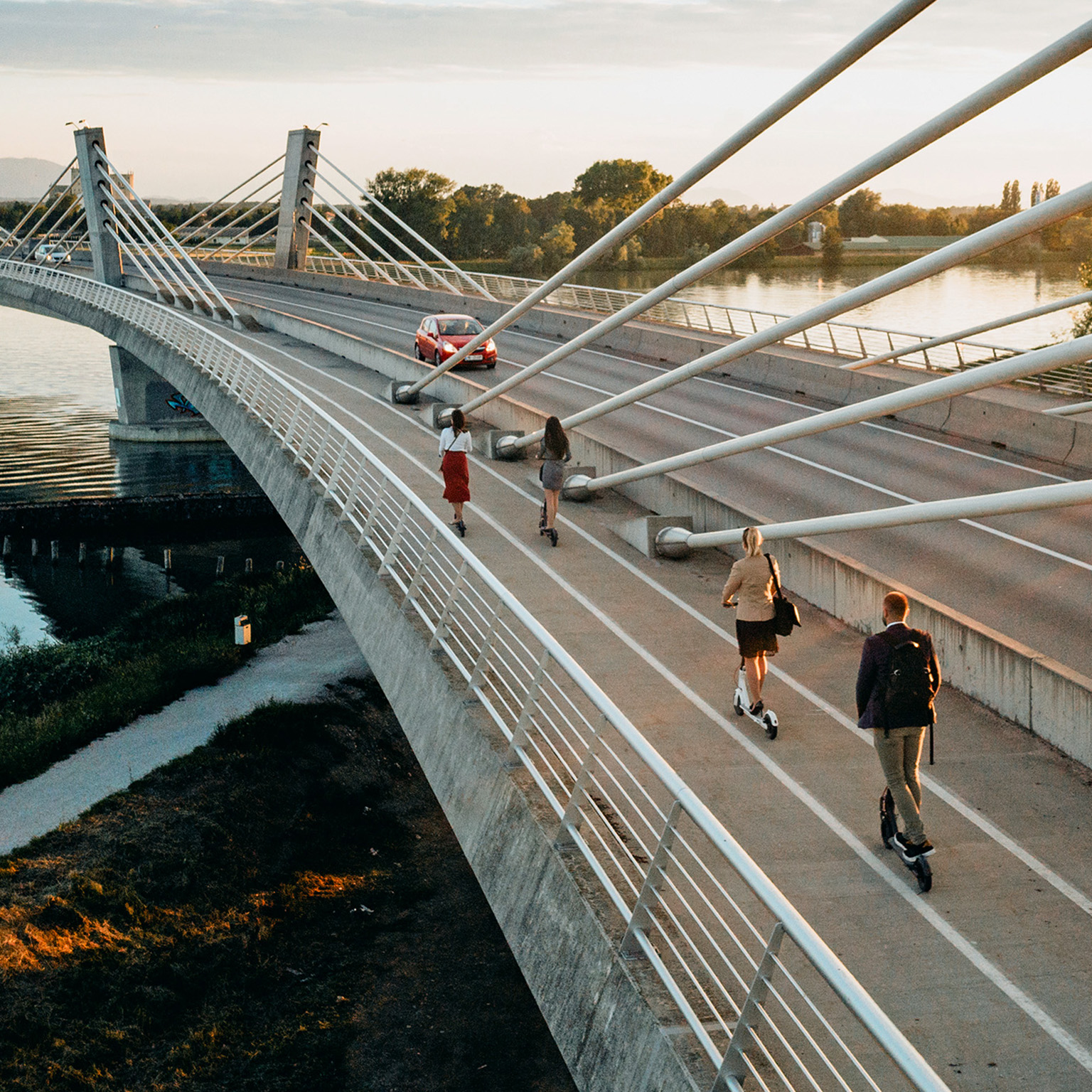 Four people on electric push scooters