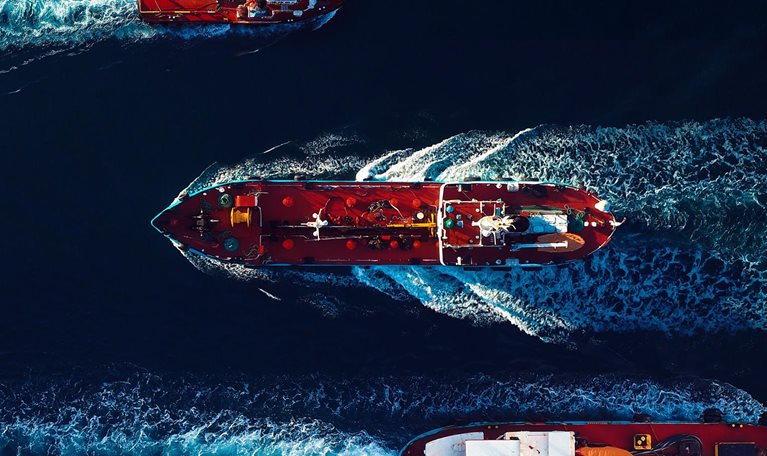 Aerial view of Oil and Gas tanker ships on the move in the harbour. - stock photo