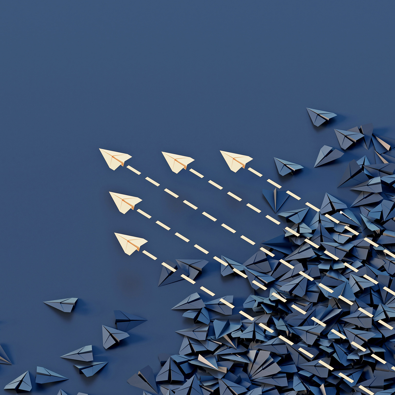 Conceptual image showing a jumble of dark paper planes with an organized group of colored planes flying through and above them.