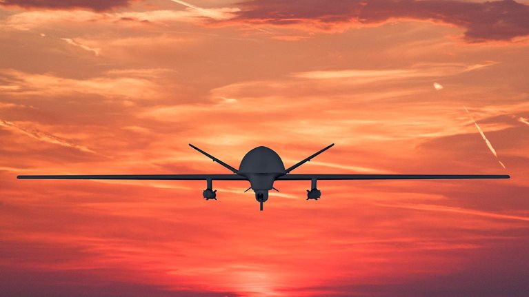 Plane flying at sunset