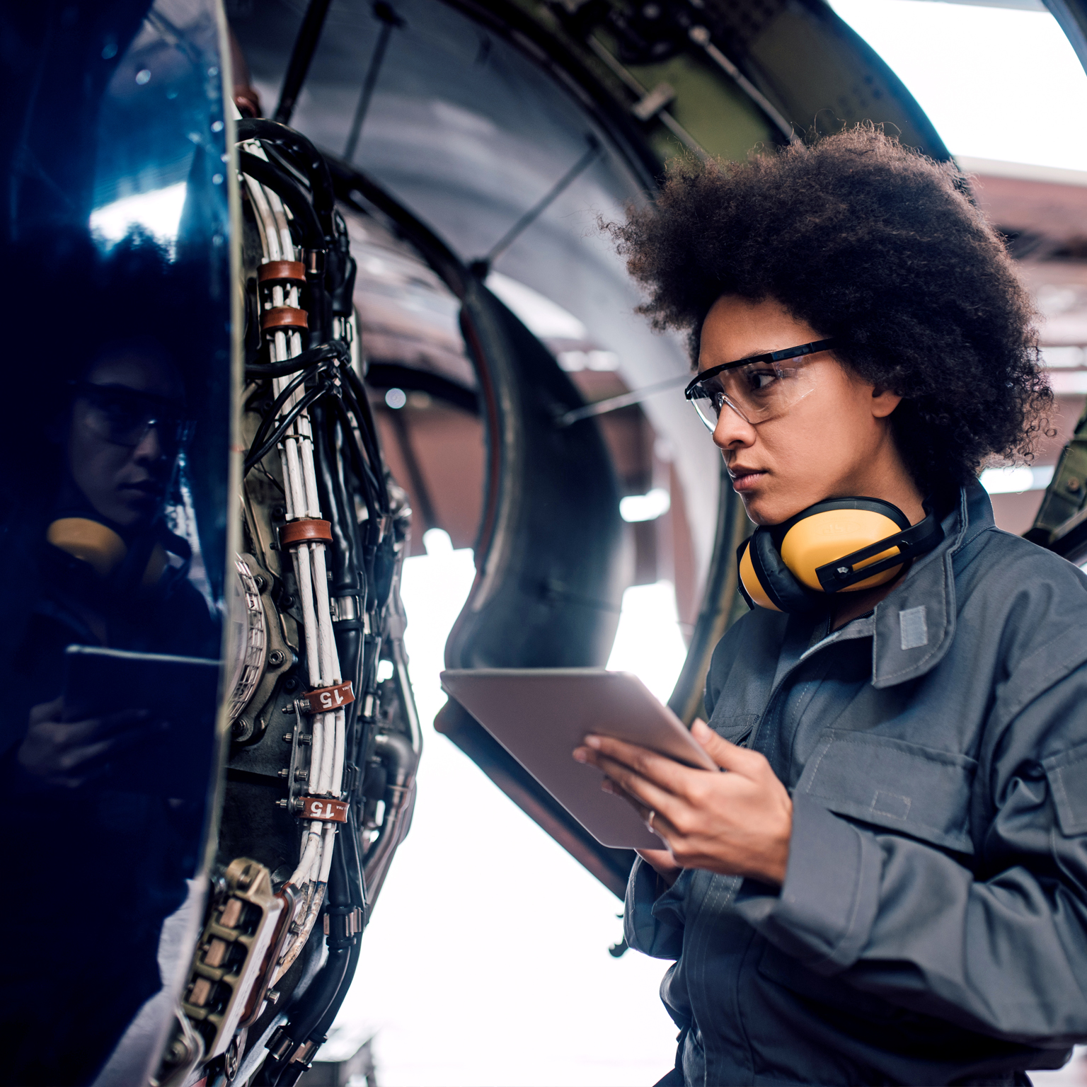 Female mechanic using digital tablet at work  - stock photo