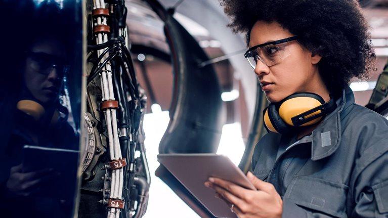 Female mechanic using digital tablet at work - stock photo