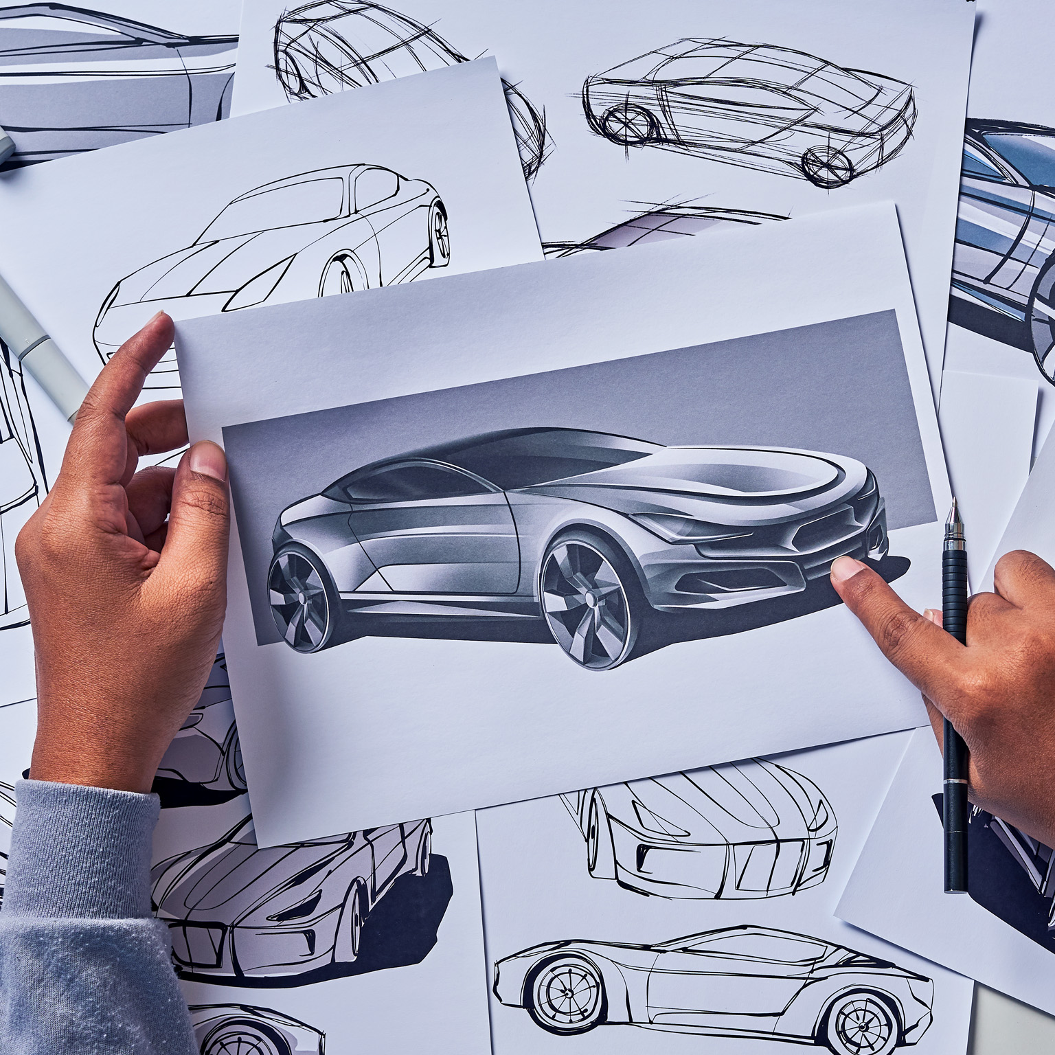 Industrial designer drawing a sketch for a concept car prototype.