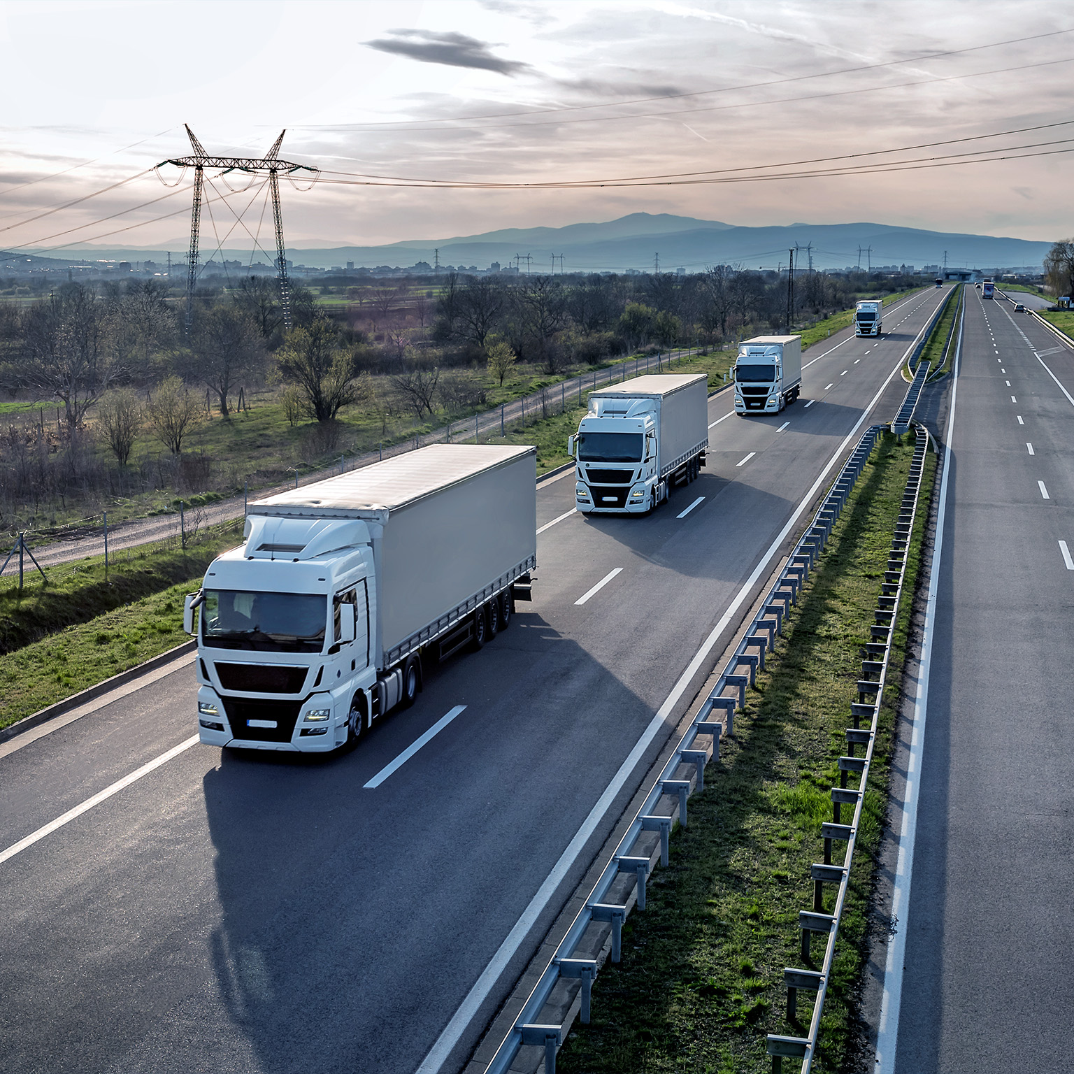 Convoy of trucks driving on a highway
