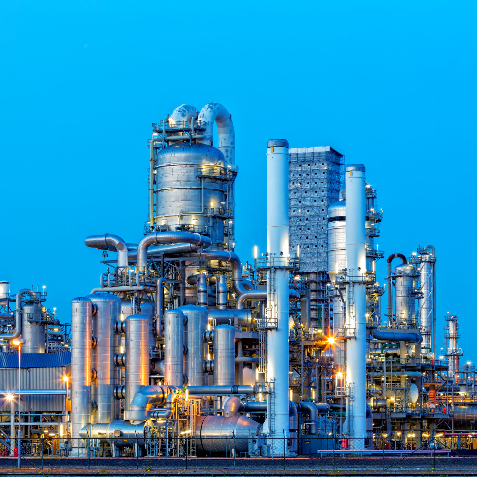 Petrochemical plant illuminated at dusk