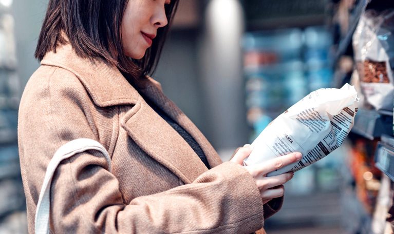 Pregnant woman shopping organic food at supermarket