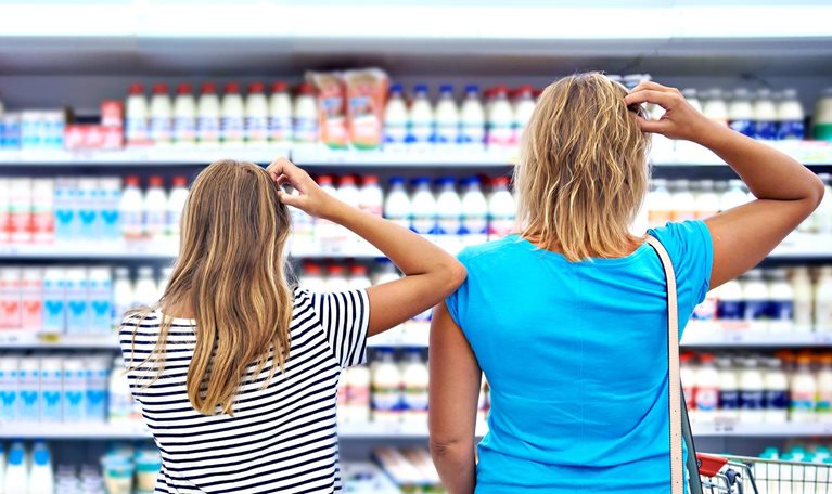 Family chooses dairy products in shop