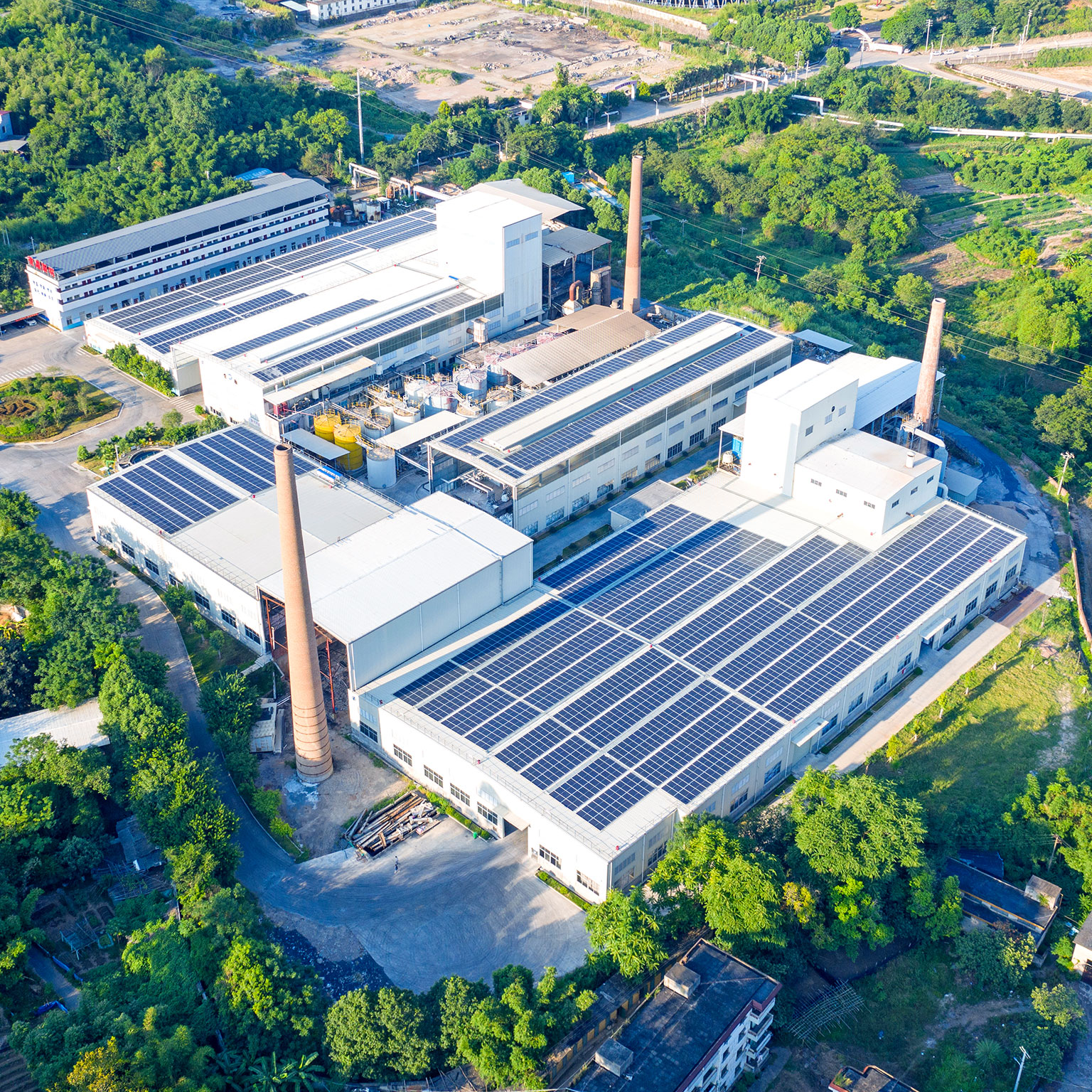 The roof of the factory is covered with solar photovoltaic panels - stock photo