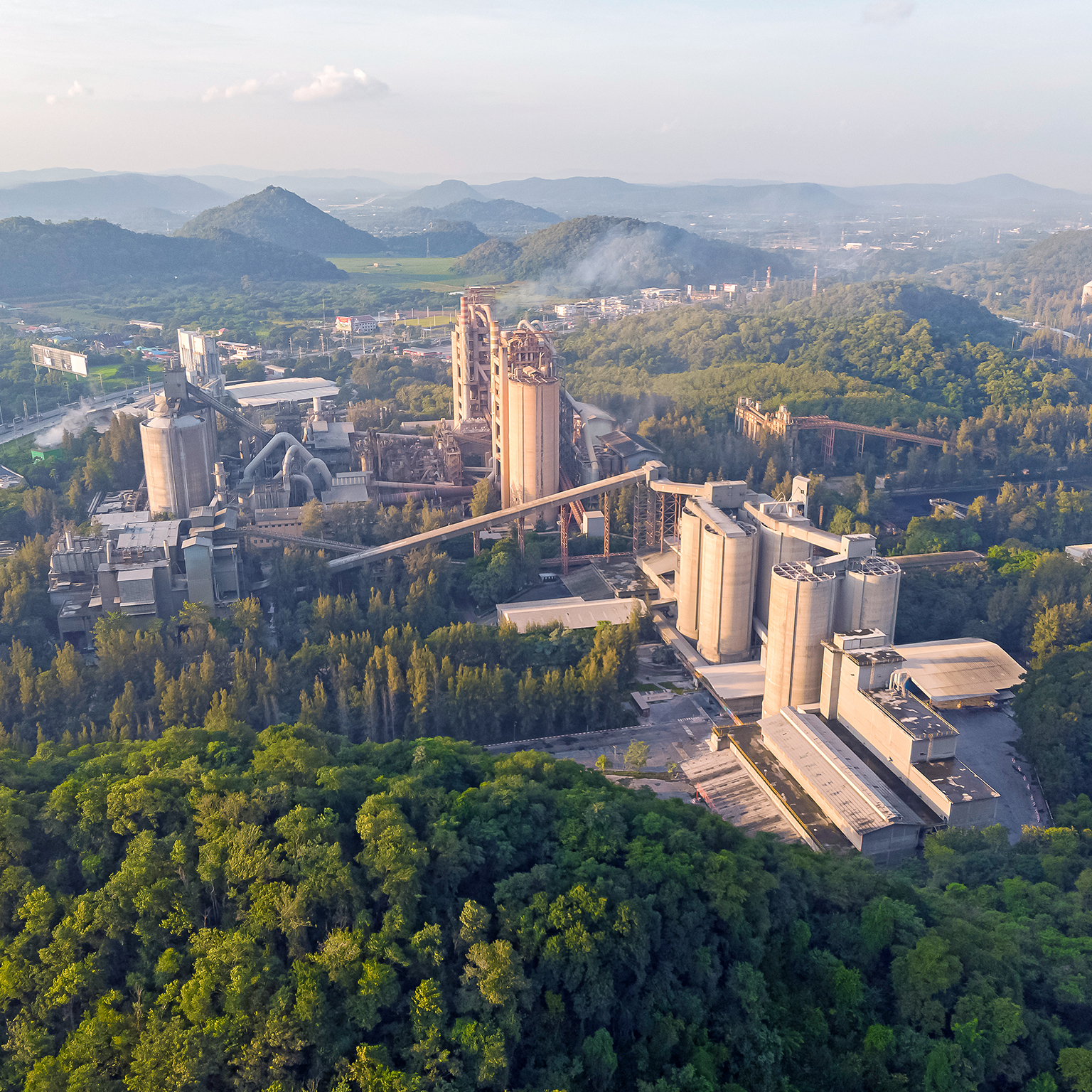 Aerial view, Golden hour cement plant business construction industrial in valley.
