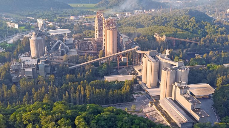 Aerial view, Golden hour cement plant business construction industrial in valley.