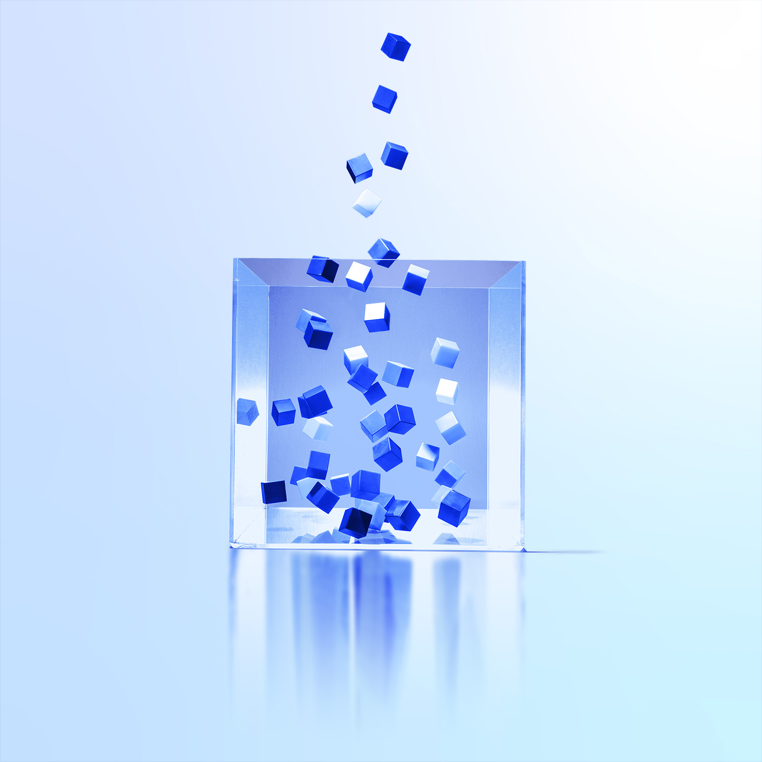 Image of multi colored cubes flowing out of clear box.