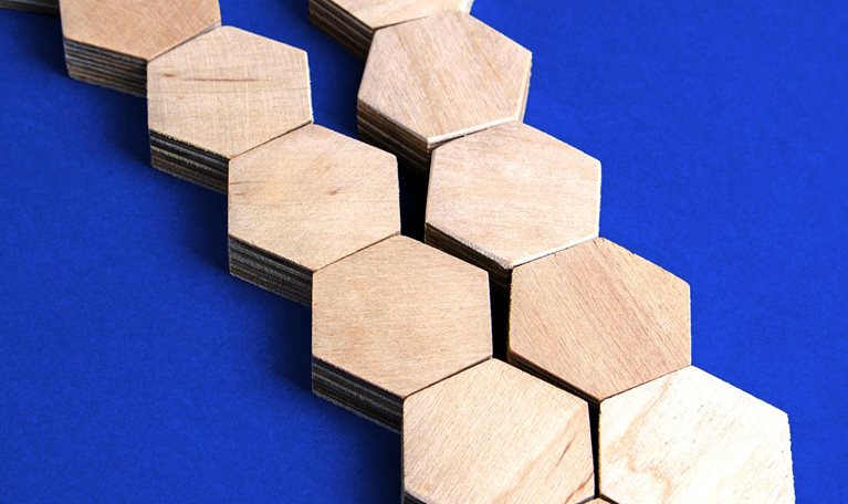 Two separate chains of wooden blocks converge to form a single chain.