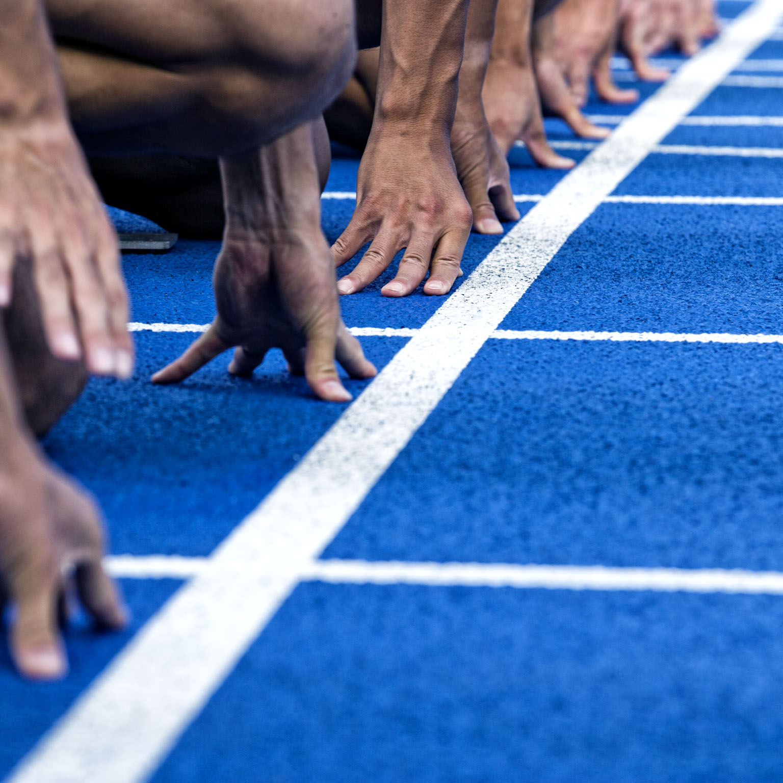 Track runners in position at the starting line of a race.