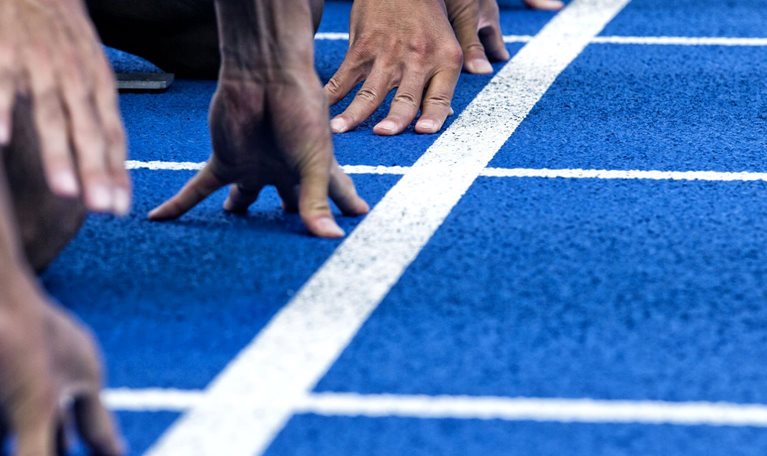 Track runners in position at the starting line of a race.