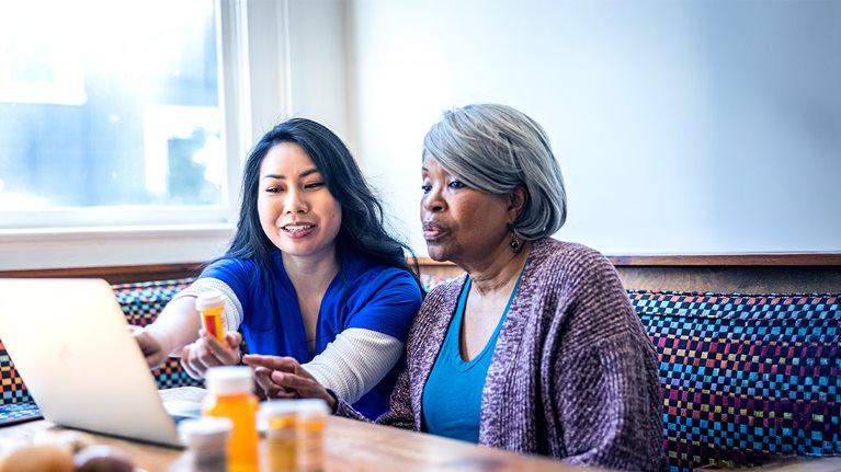 Senior woman having in-home consultation with nurse