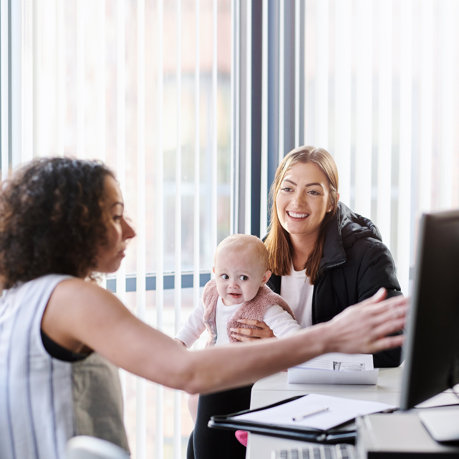Young mother with social services officer