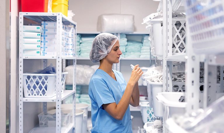 Nurse wearing face mask checking inventory at hospital