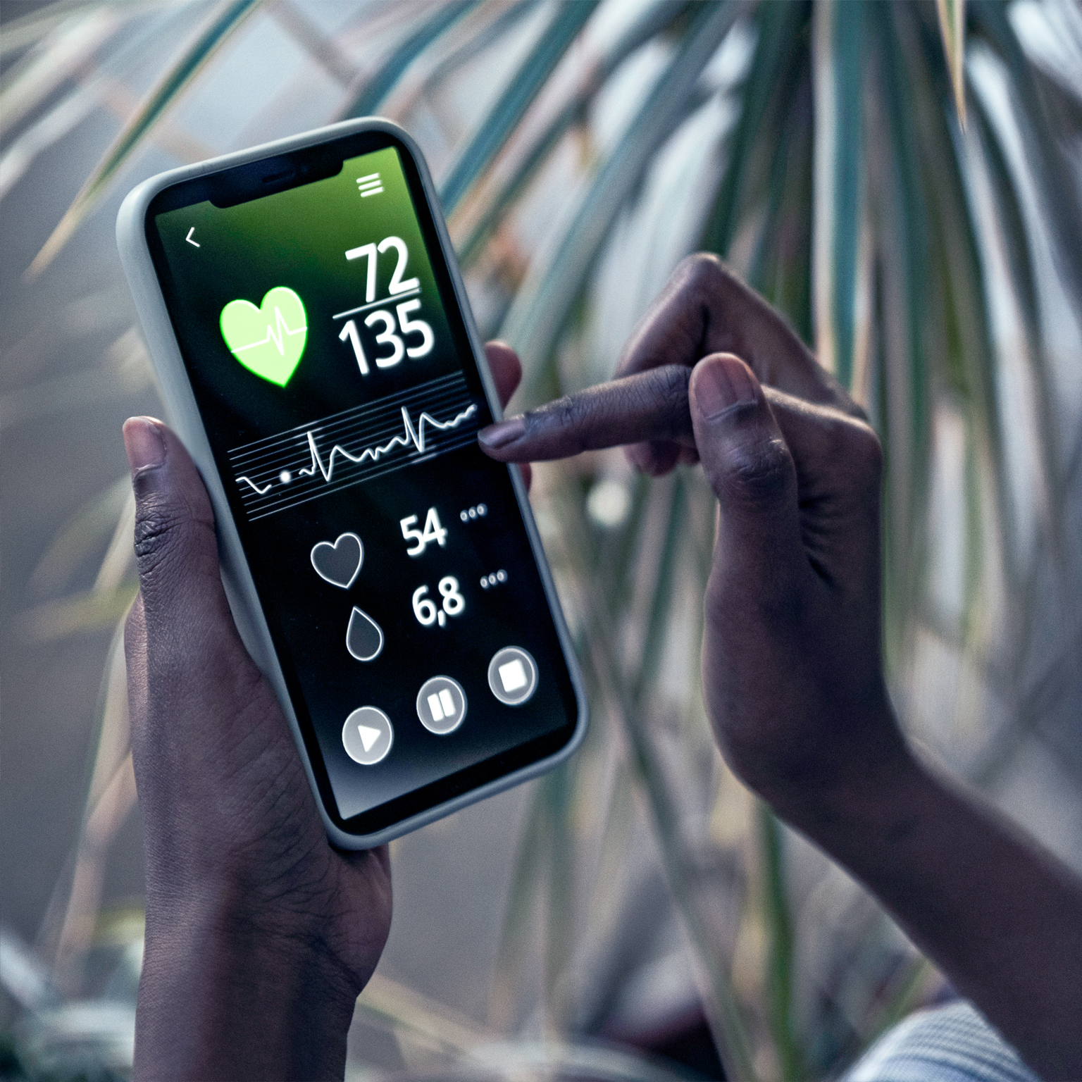 Woman checking pulse trace through mobile phone at home