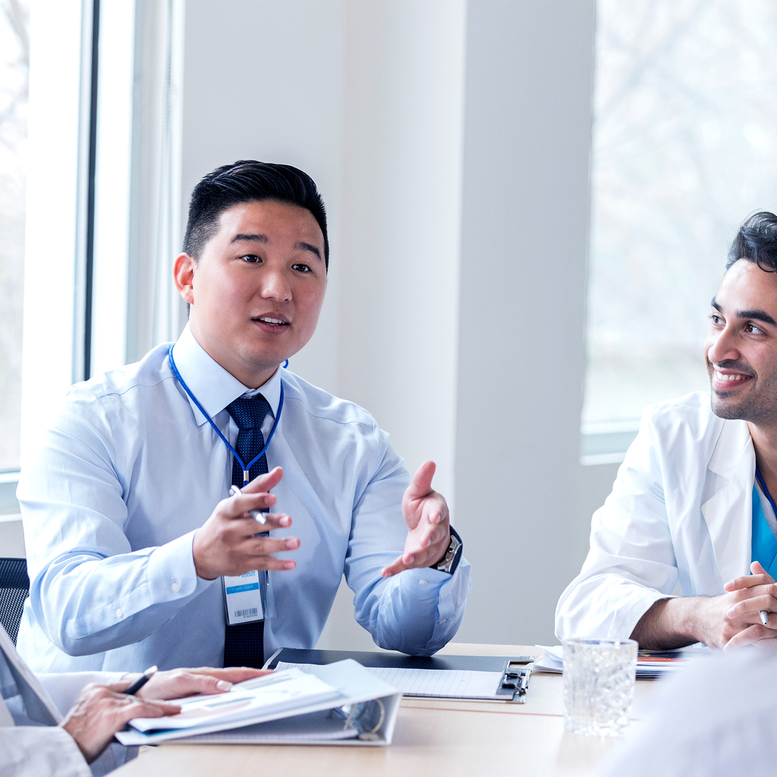 Hospital administrator conducts staff meeting