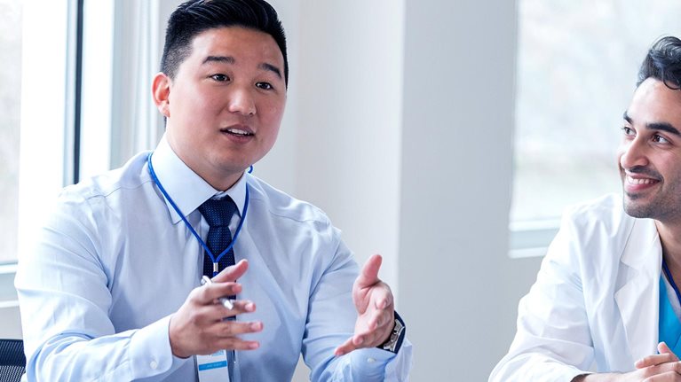 Hospital administrator conducts staff meeting