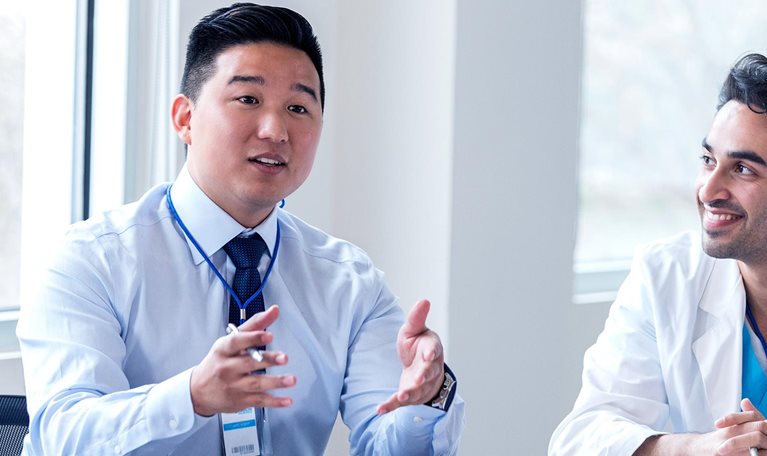 Hospital administrator conducts staff meeting