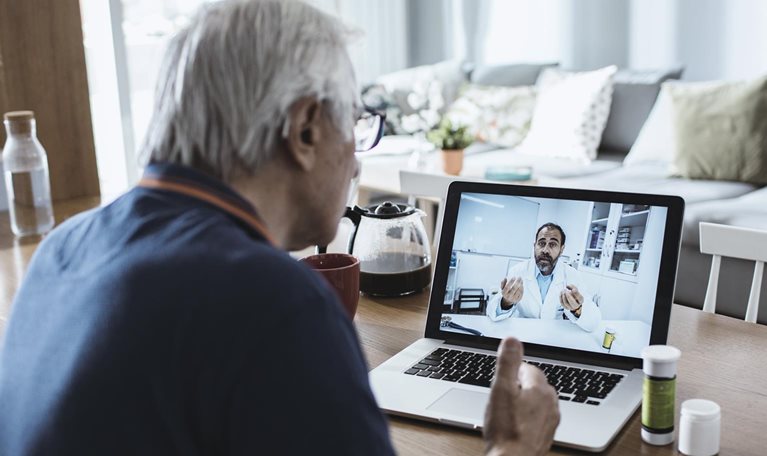 Senior man consulting with a doctor on his laptop.