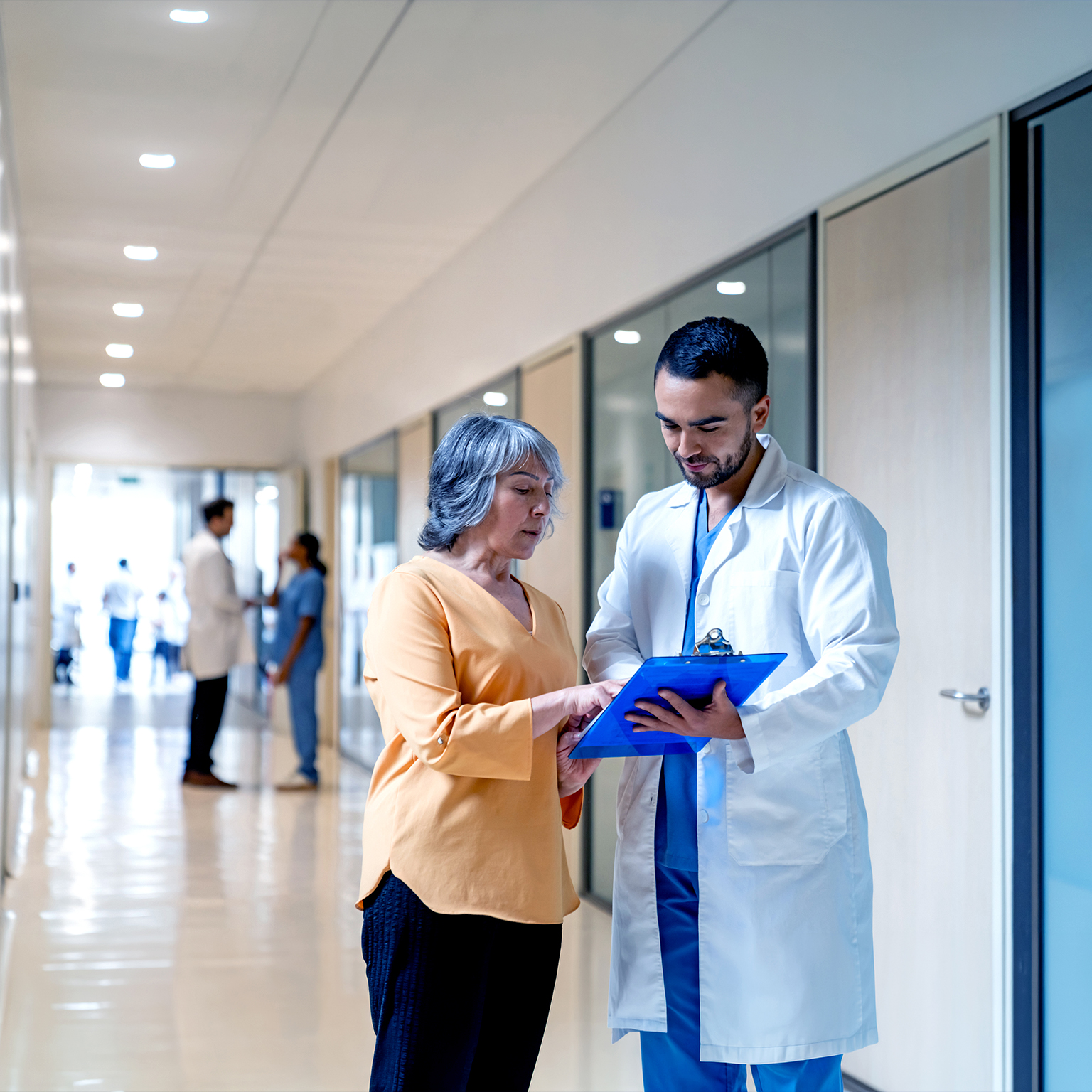 Latin American doctor explaining the test results to a senior woman at the hospital