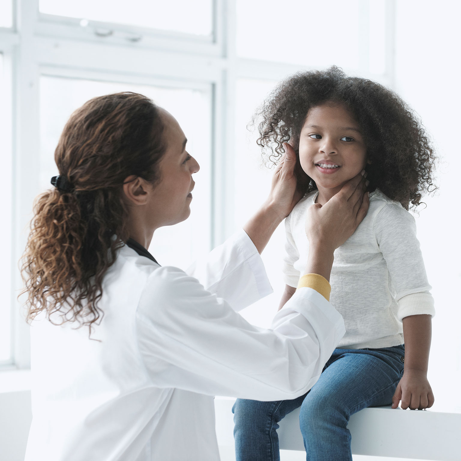 Doctor examining girl in office - stock photo