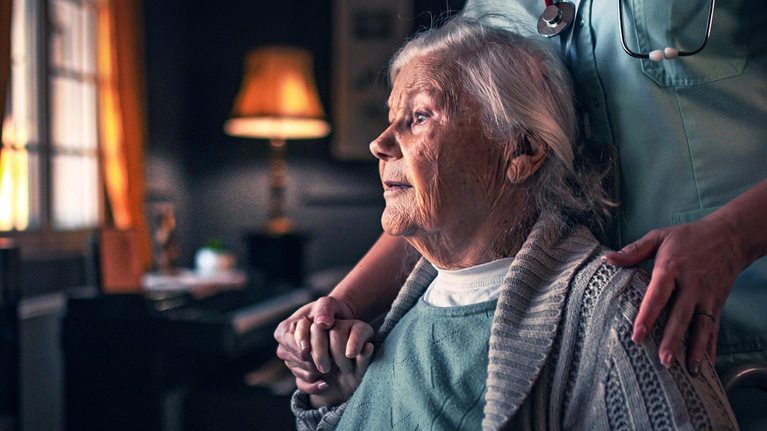 Nurse in a home visit to an elderly woman with disabilities