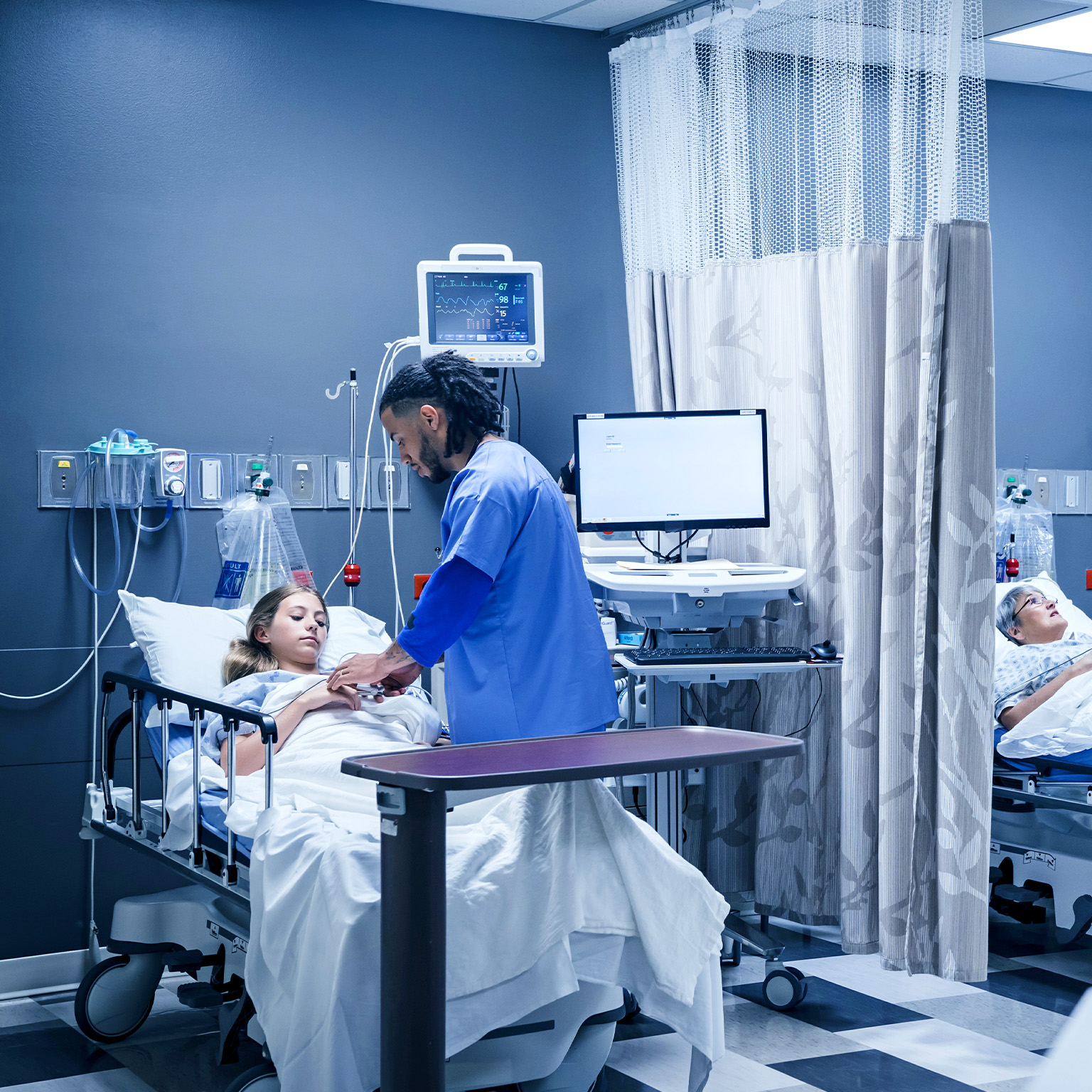 Doctor and nurse with patients in hospital