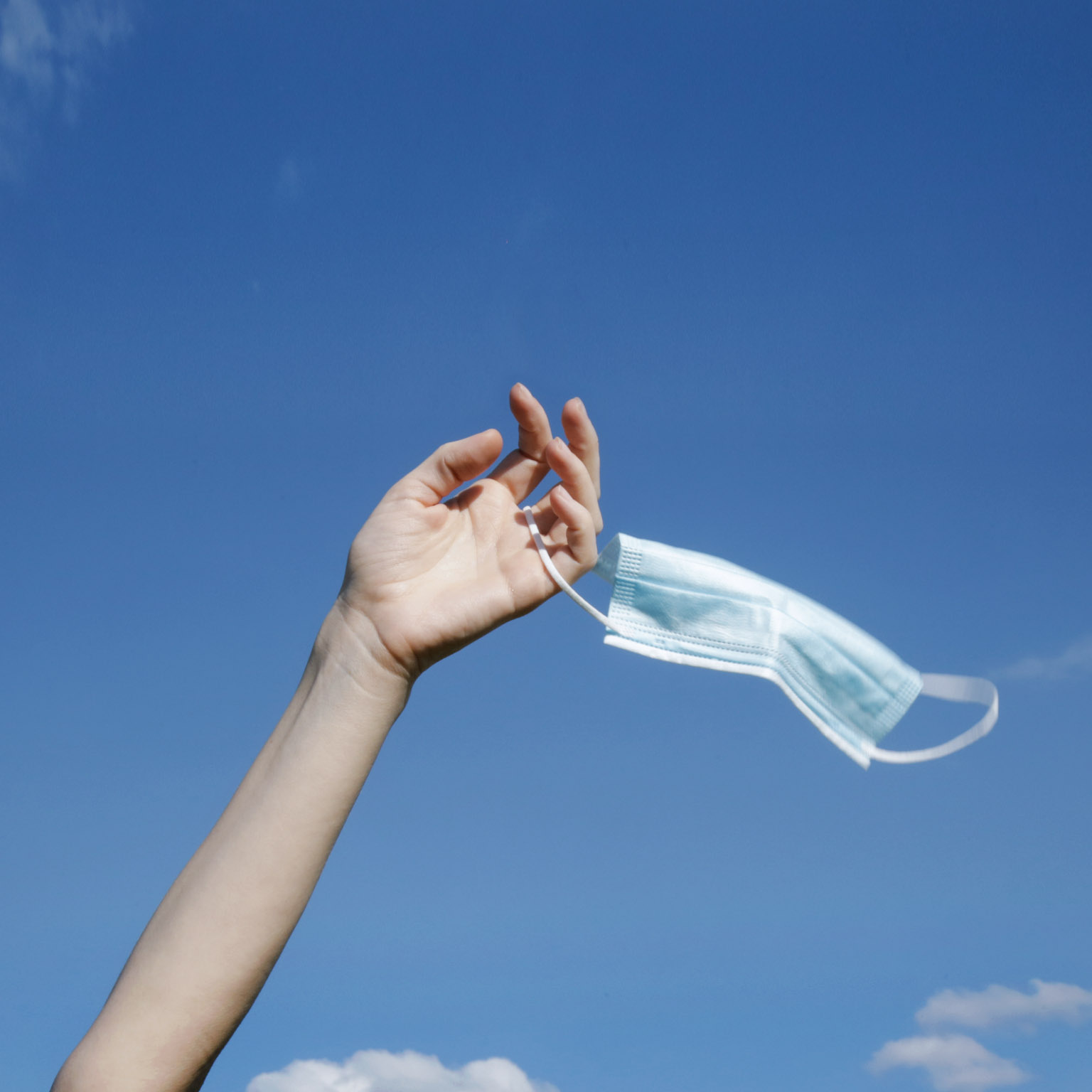 Hand holding face mask