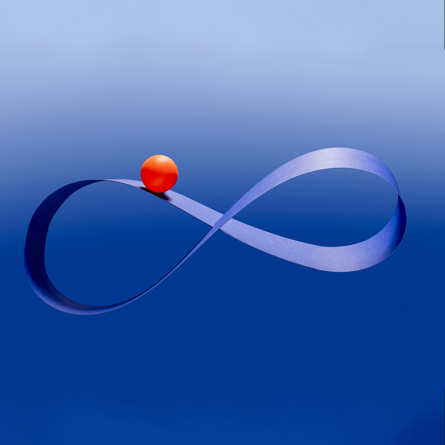 Bright red ball riding on blue mobius infinity strip in mid-air against blue background