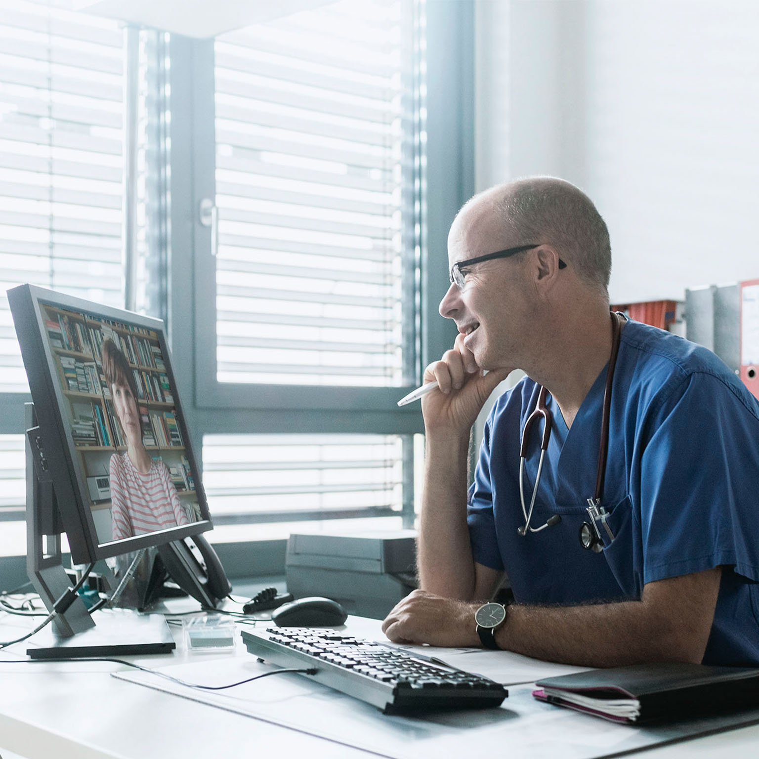 Doctor talking to woman on video call