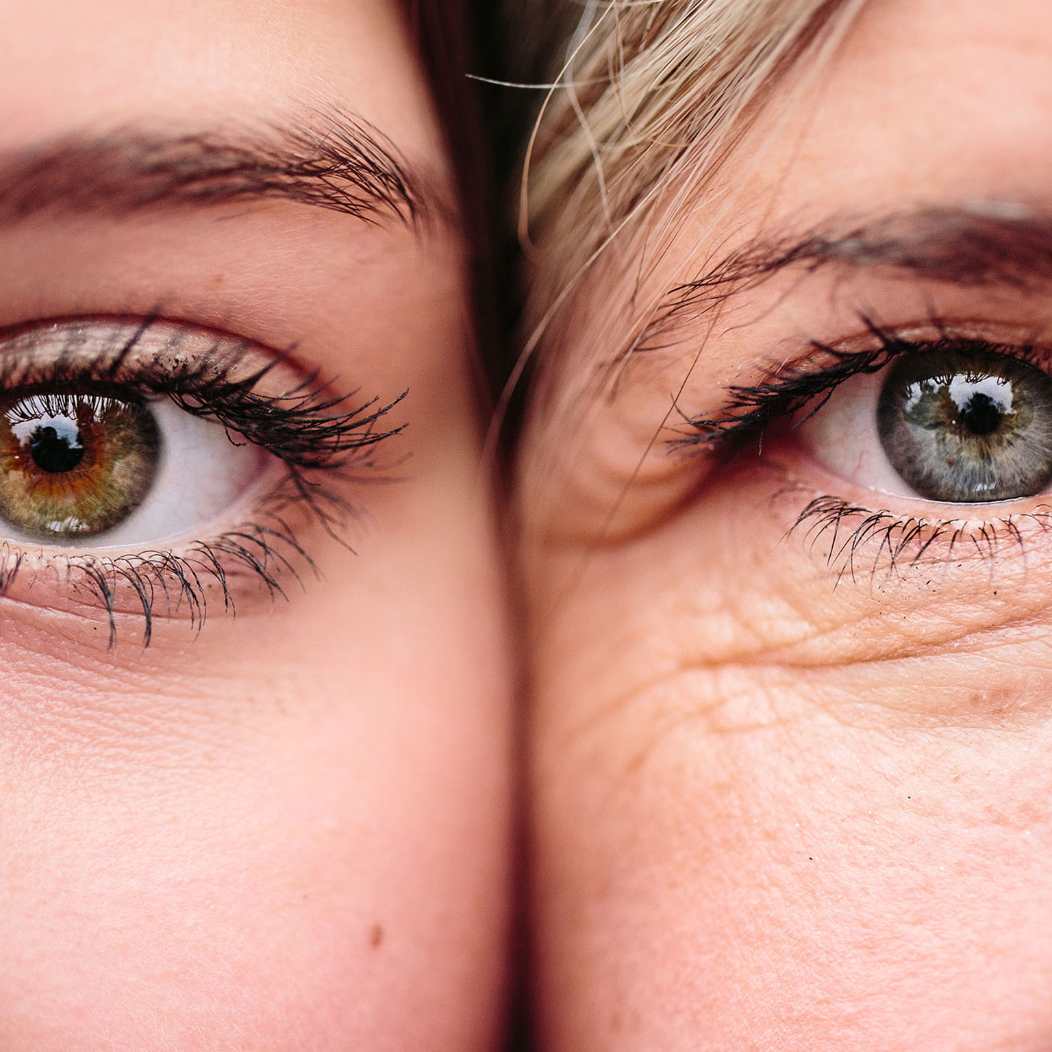 Close up on eyes of mother and daughter faces next to one another.