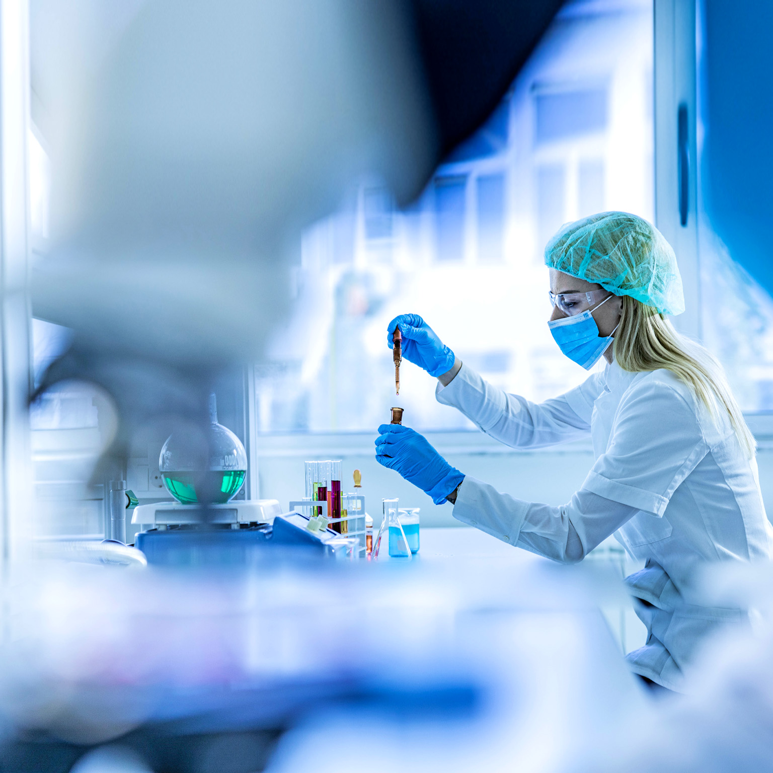 Female scientist examining toxic liquid in laboratory