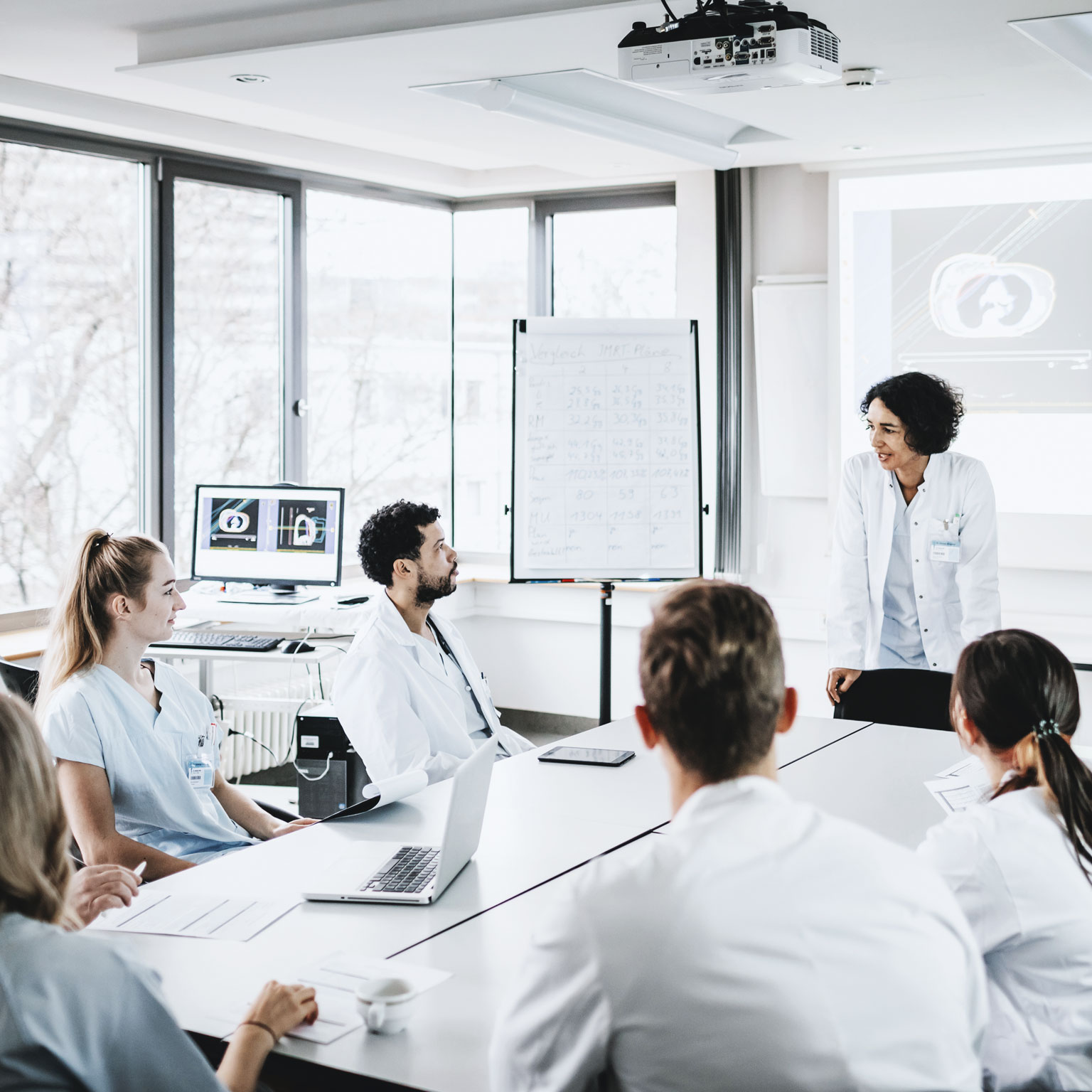 Oncologists gathered around a table.