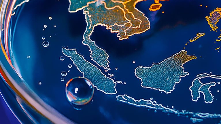 The image is a symbolic representation of climate change, depicting the Earth's landmasses as if in a petri dish with water and bubbles.