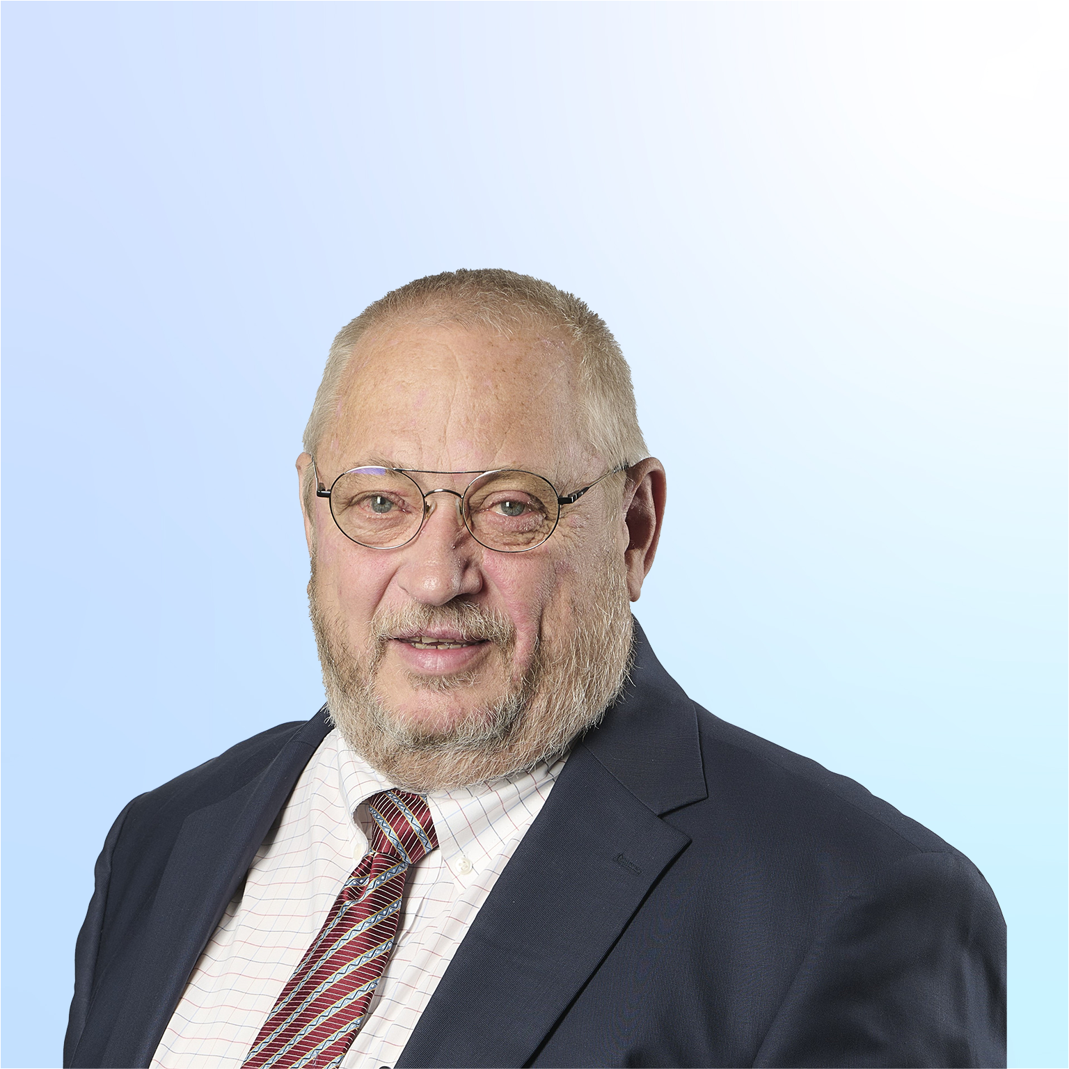 Neal Froneman in a suit against a light blue background