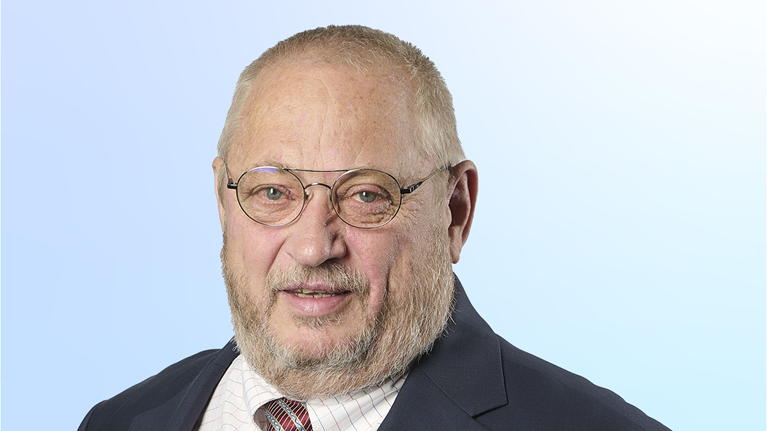 Neal Froneman in a suit against a light blue background
