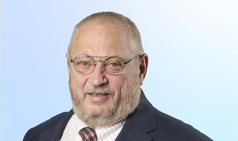 Neal Froneman in a suit against a light blue background