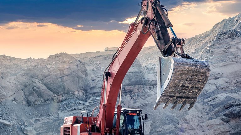 Crane digging on rocks