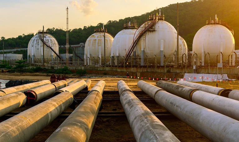 Distillation tank of oil refinery plant, morning time - stock photo