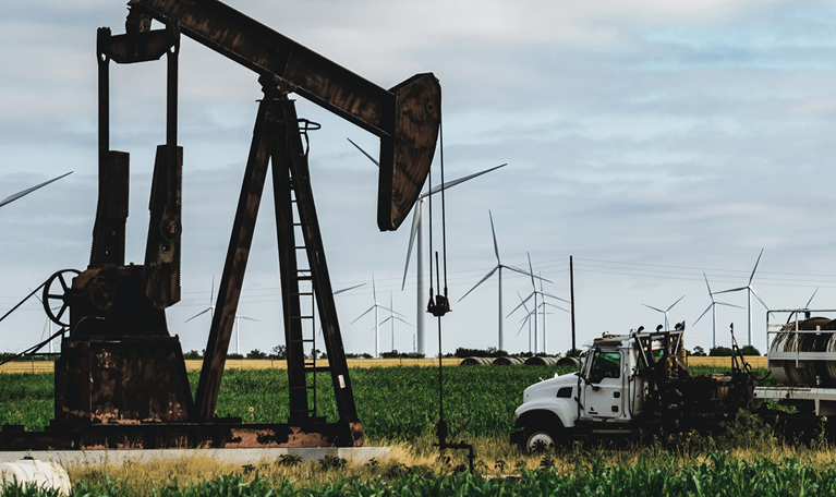 Oil rig drilling amongst crops